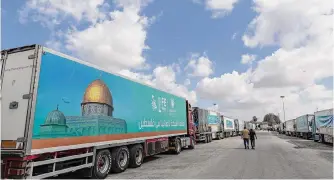  ?? Mahmoud Khaled/getty Images ?? Aid convoy trucks wait at the Rafah border crossing for clearance to enter Gaza on Thursday in North Sinai, Egypt. The aid convoy set off Saturday from Cairo for the Gaza-egypt border.