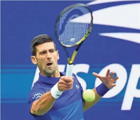  ?? ROBERT DEUTSCH/USA TODAY SPORTS ?? Novak Djokovic hits a forehand against Alexander Zverev during their U.S. Open match Sept. 10 in New York.