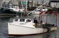  ?? AP/WAYNE PARRY ?? A fishing boat
returns to the damaged Belford port Dec. 12 in Middletown, N.J. The port sustained nearly $1 million in damage from superstorm Sandy, some of which its owners hope to recoup through federal storm aid.