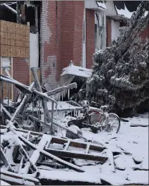  ??  ?? A bicycle stands amid the fire’s wreckage.