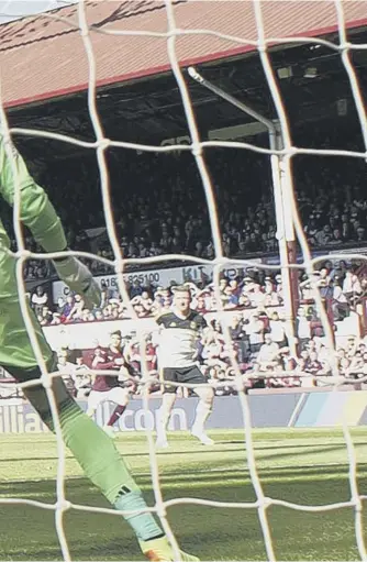  ??  ?? 0 Isma Goncalves scores the Hearts equaliser against Aberdeen in front of Archibald Leitch’s stand