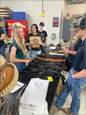  ?? Photos courtesy of Siloam Springs High School FFA ?? Siloam Springs FFA students learn about stirrups and other objects that help horse riders.