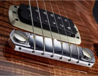  ??  ?? The straight bridge with brass inserts used on some PRS electrics has been improved and refined over many years