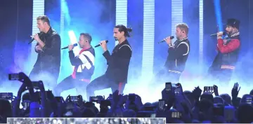  ?? — Reuters photos ?? The Backstreet Boys and Underwood (left) perform at the 2018 CMT Music Awards on Wednesday. (Far left) Shelton accepts an award on stage.
