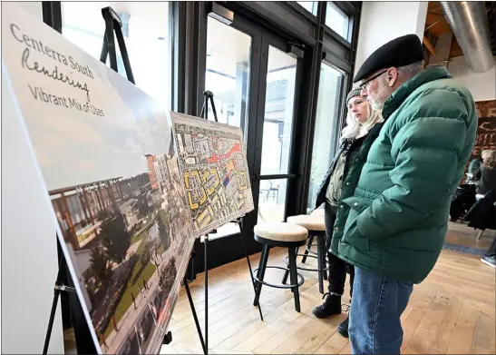  ?? JENNY SPARKS — LOVELAND REPORTER-HERALD ?? Centerra residents Rick Mason, far right, and Holly Colt, center right, look at rendreings of Centerra South Wednesday during a public meeting at Mountain Cowboy Brewing in east Loveland to discuss the proposed developmen­t.