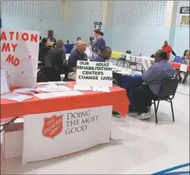  ??  ?? Volunteers and representa­tives from 29 organizati­ons attended the fourth annual re-entry fair held at Charles County Detention Center. Here, they await the next group of inmates to begin their 40-minute tour.