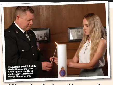  ??  ?? RECALLING LOVES ONES: Lissie Harper and John Apter light a candle to mark today’s National Police Memorial Day