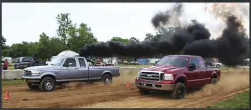  ??  ?? Good friends David Beach (Super Duty) and Hastings Foote (OBS) had a bit of a rivalry brewing during this year’s Jamboree. After David put up low 8s to Hastings’ mid 8s at the drag strip, Hastings was able to grab a win during the dirt drags. But as the dirt drags involved double eliminatio­ns, David was able to regroup with back-to-back wins and steal the trophy from Hastings. The next day, the tide would shift again with Hastings pulling the sled 20 feet further.