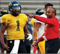  ?? AP file photo ?? Grambling senior quarterbac­k Devante Kincade (left) listens to Coach Broderick Fobbs during a practice last season in Grambling, La. Fobbs welcomes his new coaching peers in the Southweste­rn Athletic Conference and any new ideas they bring with them.