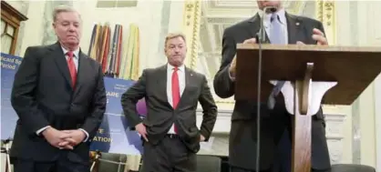  ??  ?? WASHINGTON: US Sen Dean Heller (R-NV) (2nd left) and Sen Lindsey Graham (R-SC) (left) listen during a news conference on health care at Capitol Hill in Washington, DC. Senators Graham, Cassidy, Heller and Johnson unveiled a proposed legislatio­n to...