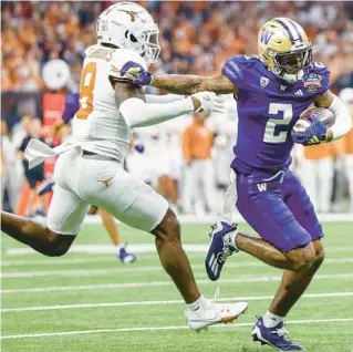  ?? AP ?? The second-ranked University of Washington Huskies played the third-ranked Texas Longhorns in the Sugar Bowl, the semifinal game of the College Football Playoffs on Monday at the Superdome, in New Orleans, Louisiana.