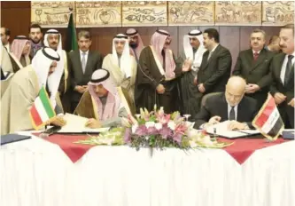  ?? — KUNA ?? BAGHDAD: Kuwait’s First Deputy Prime Minister and Foreign Minister Sheikh Sabah Al-Khaled Al-Hamad AlSabah (left) and Iraqi Foreign Minister Ibrahim Al-Jaafari sign an agreement during the sixth session of a joint Kuwaiti-Iraqi ministeria­l committee...