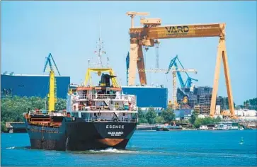  ?? Andrei Pungovschi Bloomberg ?? A CARGO ship navigates a canal near Tulcea in Romania, where ports are backed up with traffic during a surge in demand as the region desperatel­y tries to figure out how to get grain out of Ukraine.