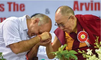  ?? — PTI ?? The Dalai Lama and deputy chief minister Manish Sisodia during the launch of Happiness Curriculum at Thyagaraj Sports Complex in New Delhi on Monday.