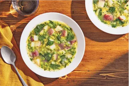  ?? TOM MCCORKLE/FOR THE WASHINGTON POST ?? Spring vegetable soup is made with early-harvest vegetables — leeks, peas, new potatoes, spinach and herbs.