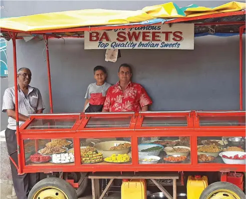  ??  ?? Virlesh Anand (right) with his son and uncle Kamal Sharma at their stall in Lautoka.