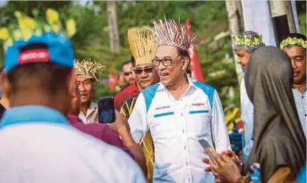  ?? PIX BY MUHD ZAABA ZAKERIA ?? PKR candidate for the Port Dickson by-election Datuk Seri Anwar Ibrahim being greeted by the residents of Kampung Bukit Kepong in Port Dickson yesterday.