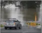  ?? MARK BAKER — THE ASSOCIATED PRESS ?? A car turns at a closed road in Richmond on the outskirts of Sydney, Australia, on Monday.