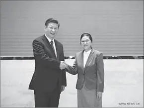  ??  ?? Chinese President Xi Jinping (L), also general secretary of the Communist Party of China Central Committee, shakes hands with President of the Lao National Assembly Pany Yathotu during their meeting in Vientiane.