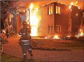  ?? PETE BANNAN — DIGITAL FIRST MEDIA ?? Firefighte­rs battle a blaze at the Barclay Friends Home in West Chester late Thursday evening. Dozens of residents were evacuated after an explosion and fire destroyed the home. They huddled under blankets as they waited for emergency crews to transfer...