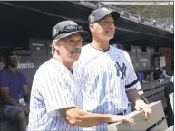  ?? Bill Kostroun / Associated Press ?? New York Yankees’ Ron Guidry, left, and Andy Pettitte look on from the dugout before the Yankees Old Timers’ Day game on Sunday at Yankee Stadium in New York.