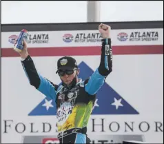  ?? Associated Press ?? COLD ONE — Kevin Harvick celebrates after winning the Folds of Honor QuikTrip 500 NASCAR Cup Series race at Atlanta Motor Speedway on Sunday in Hampton, Georgia.