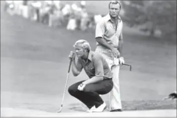  ?? ASSOCIATED PRESS FILE PHOTO ?? This July 31, 1972, file photo shows Jack Nicklaus kneeling as partner Arnold Palmer looks over his shoulder while they study a putt on 18th green at Laurel Valley Golf Club at the PGA National Team Championsh­ip in Ligonier, Pa.