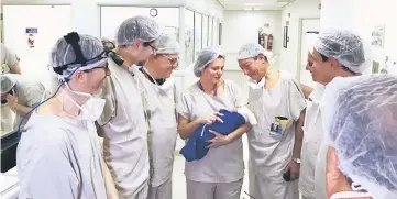  ??  ?? A medical team hold the first baby born via uterus transplant from a deceased donor at the hospital in Sao Paulo. — Reuters photo
