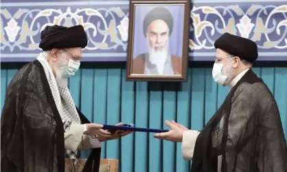  ?? Photograph: AP ?? Ayatollah Ali Khamenei, left, gives his official seal of approval to Ebrahim Raisi in Tehran, Iran on 3 August.