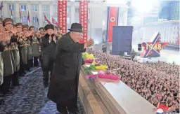  ?? AGENCY/KOREA NEWS SERVICE VIA AP
KOREAN CENTRAL NEWS ?? North Korean leader Kim Jong Un waves during a military parade Wednesday evening at Kim Il Sung Square in Pyongyang. He was accompanie­d to the event by his wife and daughter, believed to be about 10 years old.