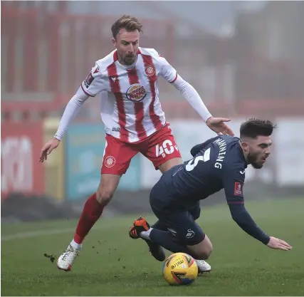  ?? Picture: Eddie Keogh/Getty ?? Chris Lines, left, playing for Stevenage in an FA Cup tie against Swansea City