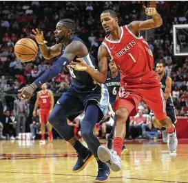  ?? Yi-Chin Lee / Houston Chronicle ?? The Rockets’ Trevor Ariza, right, will miss Wednesday’s game against the 76ers with a sprained foot suffered Monday night against Memphis.