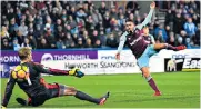  ??  ?? Touch of magic: Manuel Lanzini scores the first of his two quick-fire goals that put West Ham in command