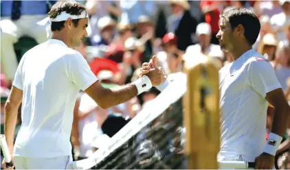  ??  ?? Roger Federer, left, shakes hands with Dusan Lajovic of Serbia after defeating him in the first round match yesterday at Wimbledon Photo: AP