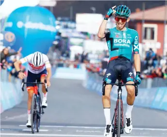  ?? AFP photo — ?? Team Bora’s rider Kamna celebrates as he crosses the finish line, ahead of Team Trek’s Spanish rider Juan Pedro Lopez (left), to win the 4th stage of the Giro d’Italia cycling race, 172 kilometers between Avola and Etna-Nicolosi, Sicily.