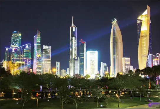  ??  ?? Kuwait City at night seen through Al-Shaheed Park. – Noura Edhbayah-KUNA
