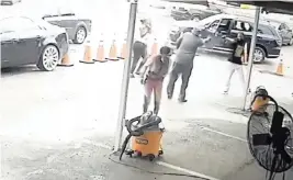  ?? ?? A still shot from surveillan­ce video shows the October 2021 shooting of Miami car wash owner John Haugabook; of the two men holding guns, he is on the left.
