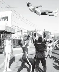  ??  ?? Cheerleade­rs putting on a show at the 21st staging of the Sagicor Sigma Corporate Fun Run/Walk on Sunday.