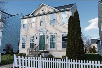  ?? BY KATHY TYLER CONTRIBUTE­D PHOTO ?? White vinyl picket fence accents the front yard of this 2-story home in the Yankee Trace community. The home has three bedrooms and a finished basement.