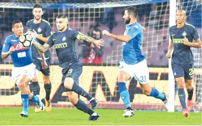  ??  ?? Inter’s Mauro Icardi, centre, and Napoli’s Raul Albiol, right, and Allan vie for the ball during last night’s match in Naples Photo: AP