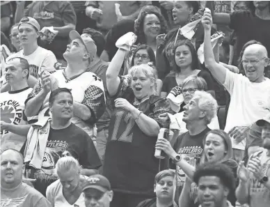  ?? PHOTOS BY ROB SCHUMACHER/THE REPUBLIC ?? Rattlers fans celebrate a touchdown against the Sioux Falls Storm in the first half during the United Bowl on Saturday night at Gila River Arena.