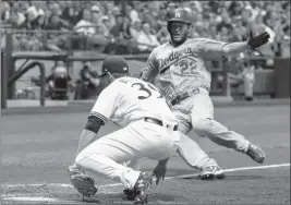  ?? ASSOCIATED PRESS ?? MILWAUKEE BREWERS’ CORBIN BURNES tags out Los Angeles Dodgers’ Clayton Kershaw during the fifth inning of a baseball game Saturday in Milwaukee. Kershaw tried to score from third on a pitch that got passed catcher Erik Kratz.