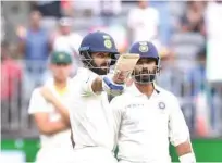  ?? Associated Press ?? India’s captain Virat Kohli celebrates after scoring a fifty against Australia during their second Test at Perth on Saturday.