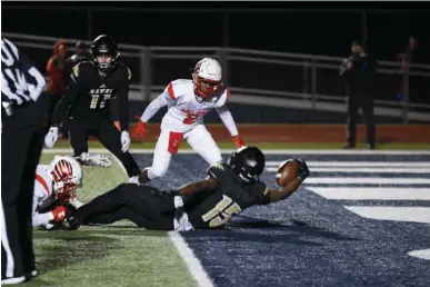  ?? Photo by Kevin Sutton ?? Pleasant Grove fullback T.J. Cole lands in the end zone for one of his four touchdowns during a 55-14 Hawk victory over Melissa on Friday in the Region II-4A, Division II championsh­ip game at Paris’ Wildcat Stadium. The Hawks advance to the state...