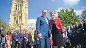  ?? Picture: PA. ?? First Minister and SNP leader Nicola Sturgeon and the party’s Westminste­r leader Angus Robertson at a photo call with SNP MPs outside the Houses of Parliament in London.