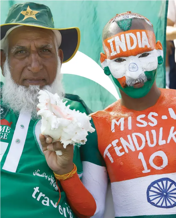  ?? Reuters file ?? Pakistani and Indian fans show their loyalty towards their teams ahead of a World Cup match. —