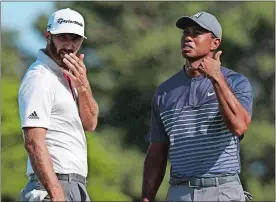  ?? CAROLYN KASTER/AP PHOTO ?? Tiger Woods, right, motions to call over an official after the wind moved his ball on the tenth green after he had already addressed it during the first round of the U.S. Open at Thursday at Southampto­n, N.Y. Dustin Johnson looks on.