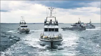  ??  ?? Four Archer class P2000 patrol boats together at sea.