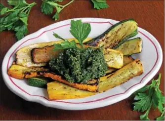  ?? PHOTO BY EMILY RYAN ?? Jalapeño chimichurr­i tops grilled summer squash for an easy crowd-pleaser.