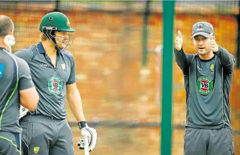  ?? PHOTO: GETTY IMAGES ?? POINTING THE WAY: Michael Clarke talks to Shane Watson in the nets at The Oval.